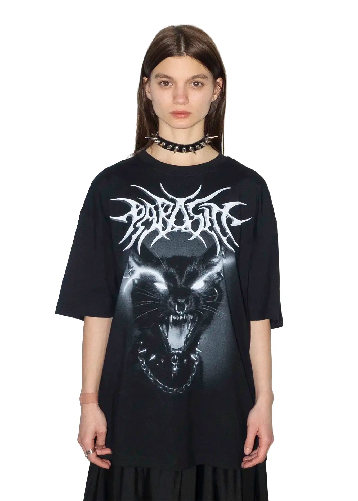 Person wearing a black t-shirt with a Parasite Label screaming punk cat graphic design and text on a white background