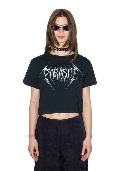 Person wearing a black t-shirt with  Parasite Label chrome 3d text logo and sunglasses on a white background
