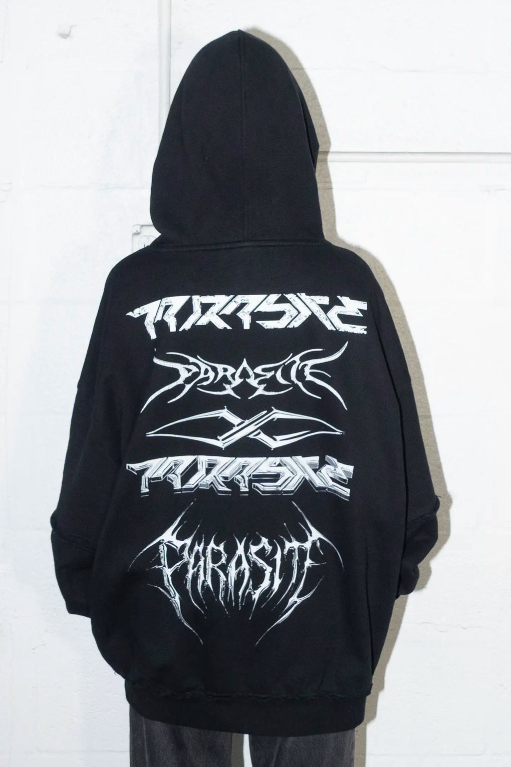 Black hoodie with white Parasite Label stacked logos designs on a white background