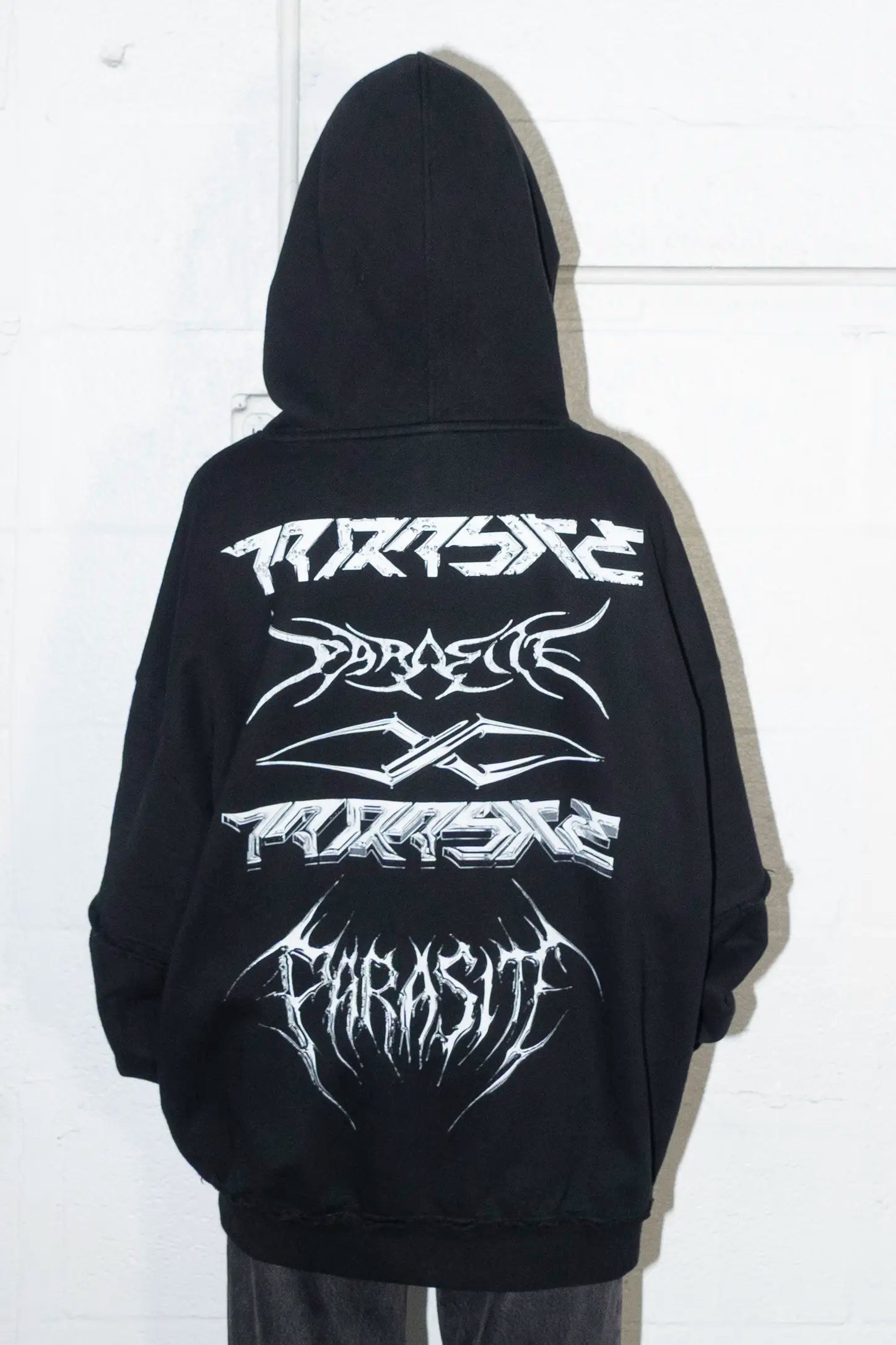 Black hoodie with white Parasite Label stacked logos designs on a white background