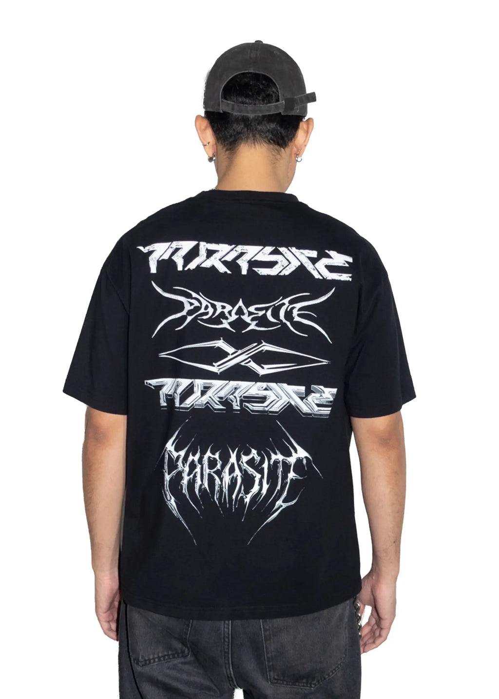 Person wearing a black t-shirt with white Parasite Label text designs on the back, standing against a white background.