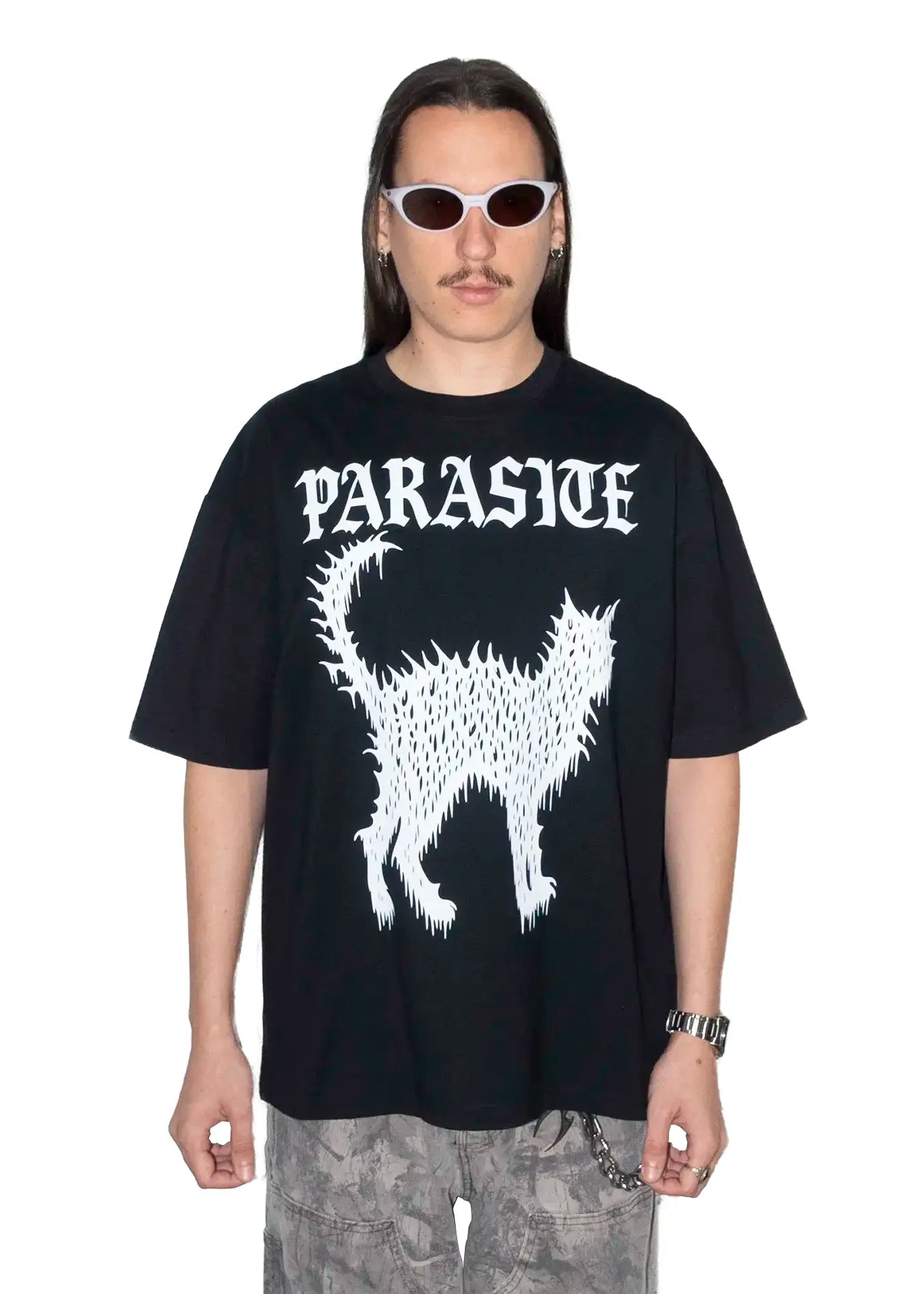 Person wearing a black t-shirt with Parasite Label logo and cat design on a white background